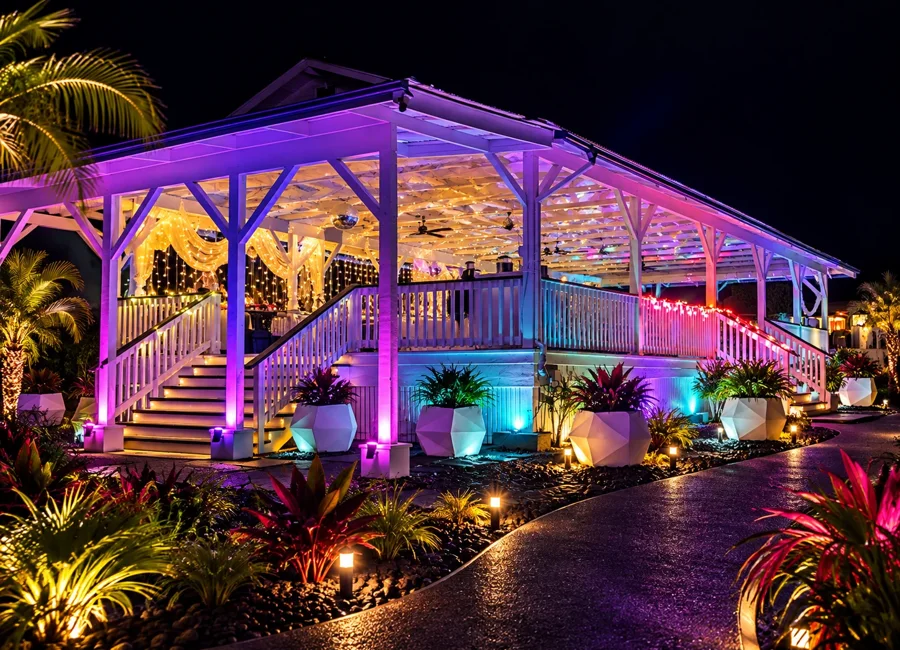 Pavilion entrance with colorful event uplighting at twilight