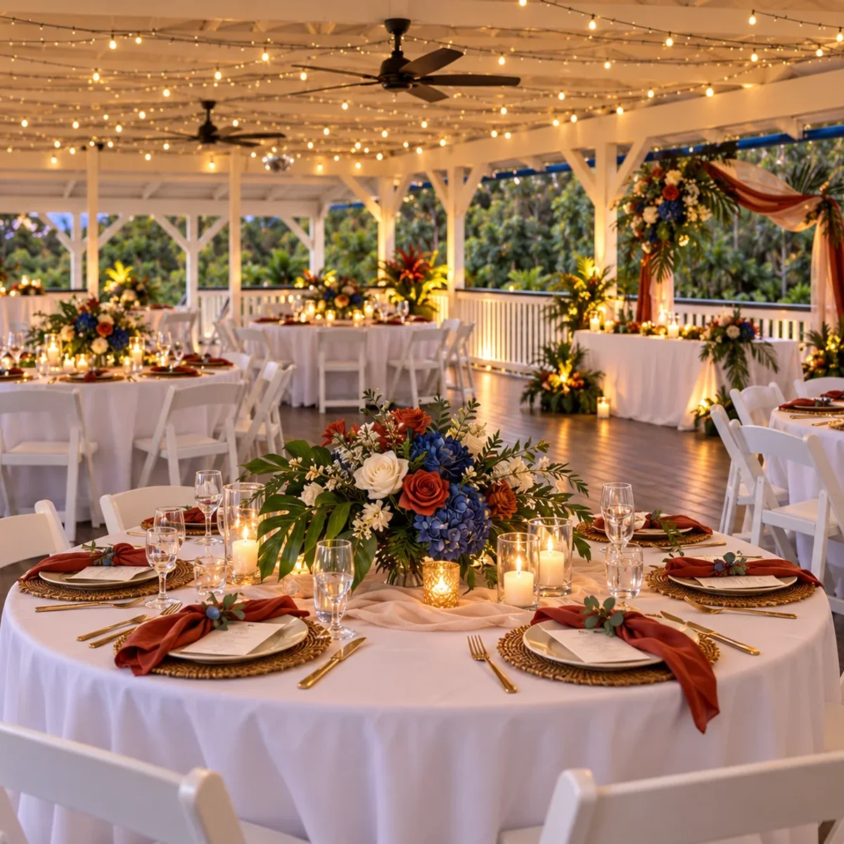 Reception tables styled in rust, navy and tropical florals inside the pavilion