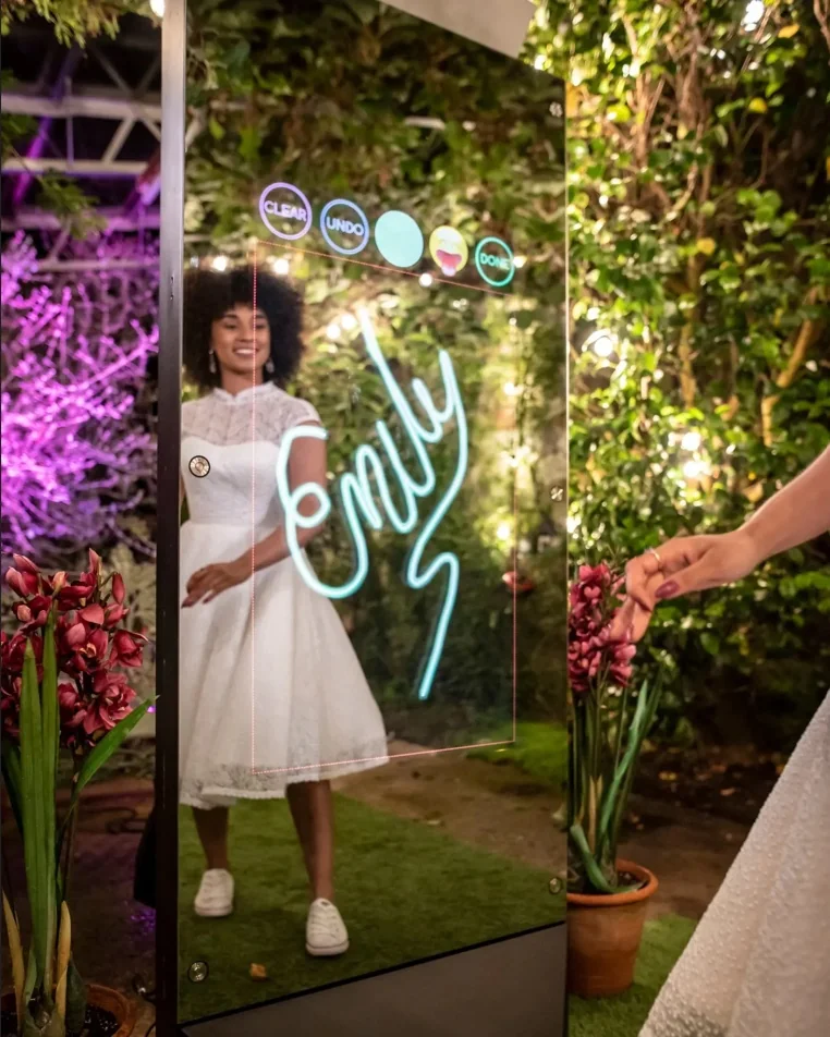 Mirror X example: a guest signs her photo on the full-length interactive touchscreen