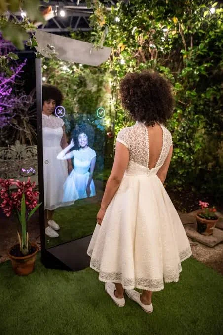 Guest in a white dress posing for the full-length Mirror X photo booth