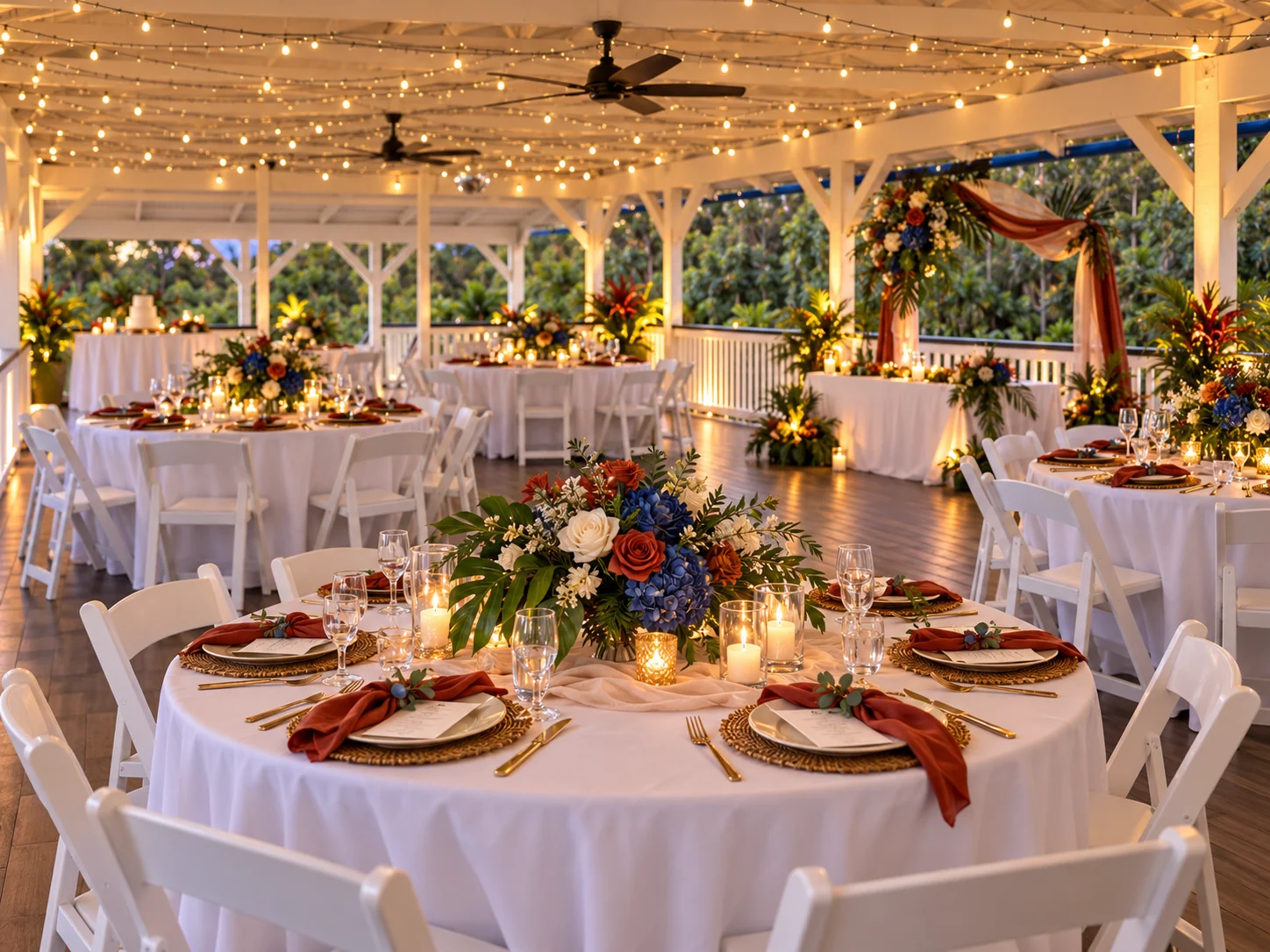 Reception tables styled in rust, navy and tropical florals inside the pavilion